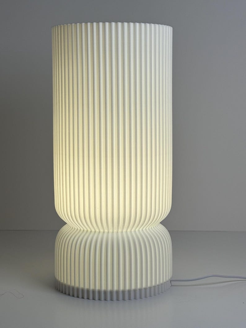 Modern table lamp with ribbed design on a gray background