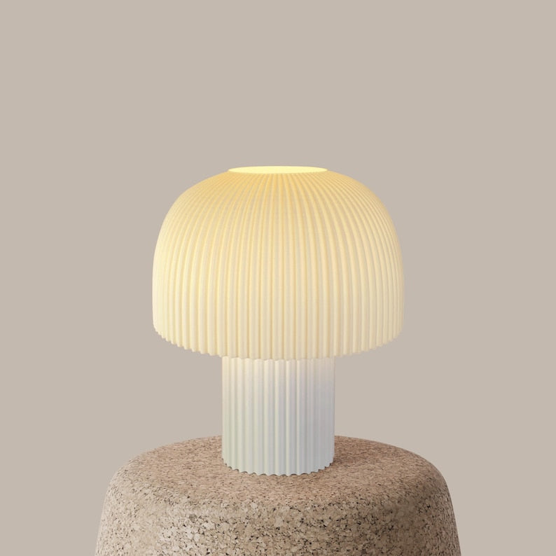 Table lamp with ribbed design on a textured base against a plain background